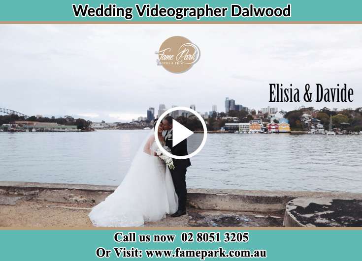 The newlyweds kissing near the shore Dalwood NSW 2335