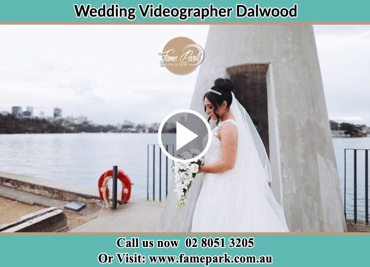 The Bride holding a bouquet of flowers near the shore Dalwood NSW 2335