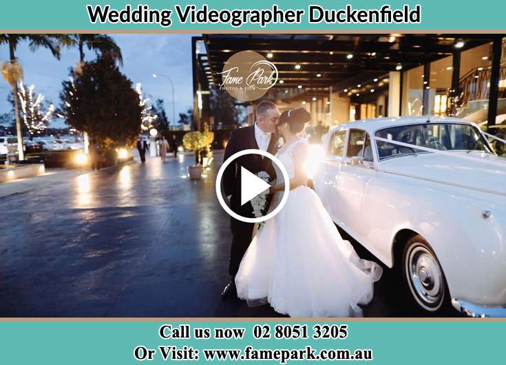 The newlyweds kissing near the wedding car Duckenfield NSW 2321