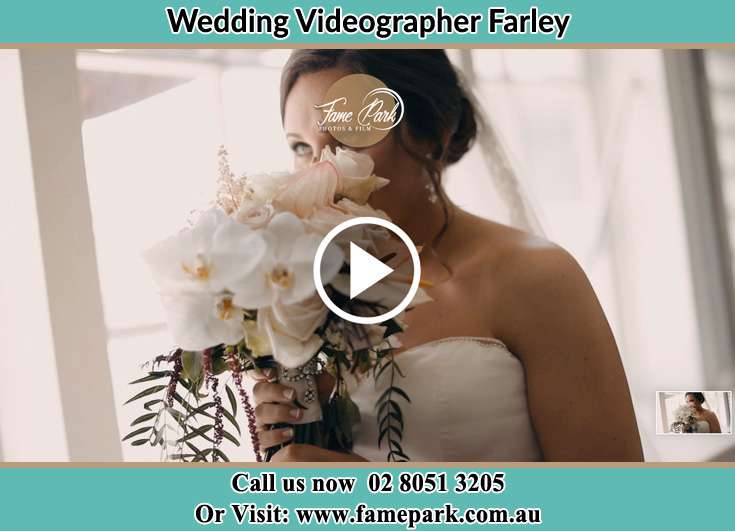 The Bride smelling a bouquet of flowers Farley NSW 2320