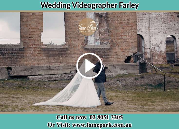 The Groom and the Bride walking through the ruins Farley NSW 2320