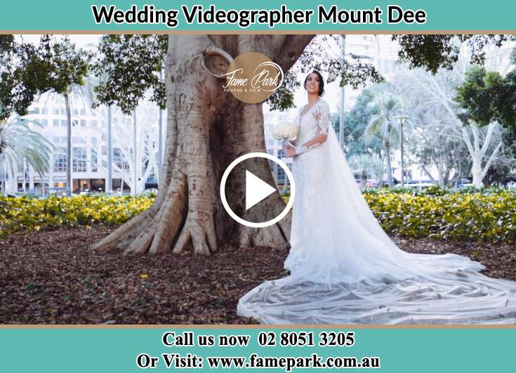 The Bride holding a bouquet of flowers under the tree Mount Dee NSW 2320