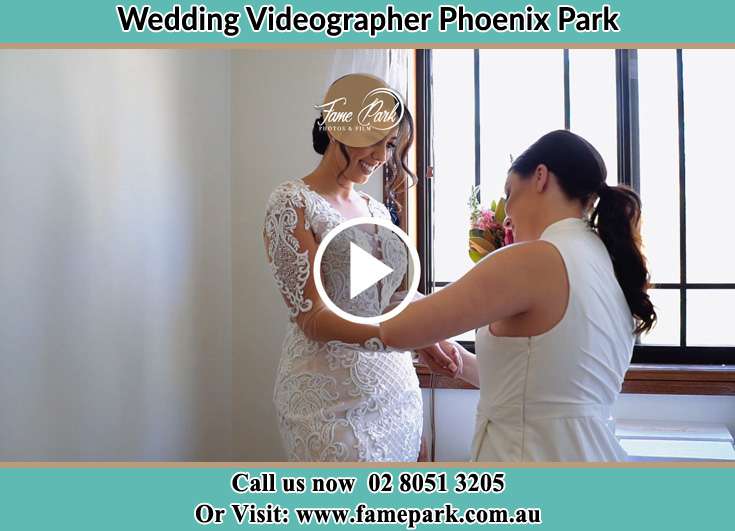 A woman helping the Bride to get ready for the wedding Phoenix Park NSW 2321