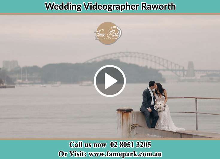 The newlyweds kissing near the shore Raworth NSW 2321