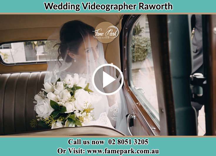 The Bride holding a bouquet of flowers inside the wedding car Raworth NSW 2321