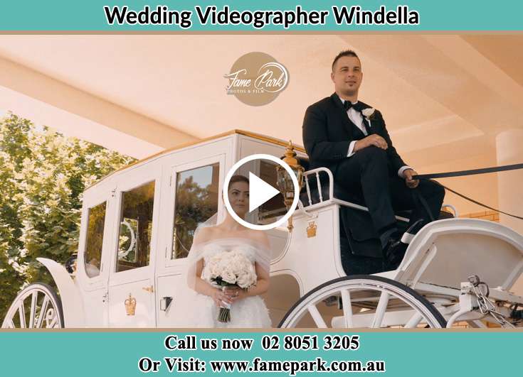 The newlyweds pose for the camera with the wedding carriage Windella NSW 2320